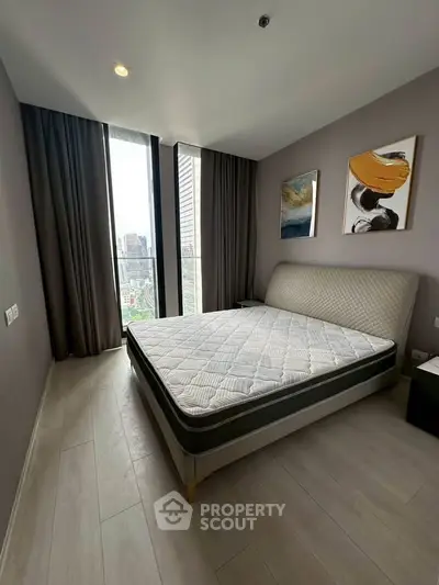 Modern bedroom with large windows and stylish decor in urban apartment