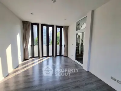 Spacious modern living room with large windows and sleek flooring