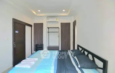 Modern bedroom with sleek design and air conditioning, perfect for comfort and relaxation.