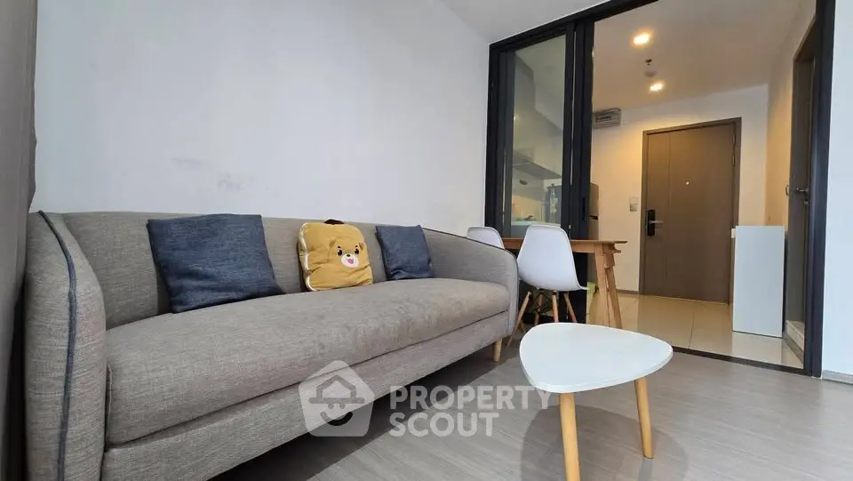 Cozy living room with modern sofa and stylish decor in a contemporary apartment.