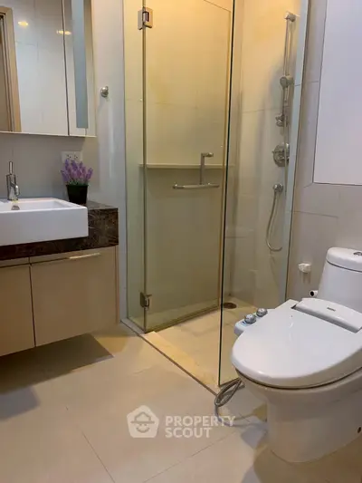 Modern bathroom with glass shower and sleek fixtures