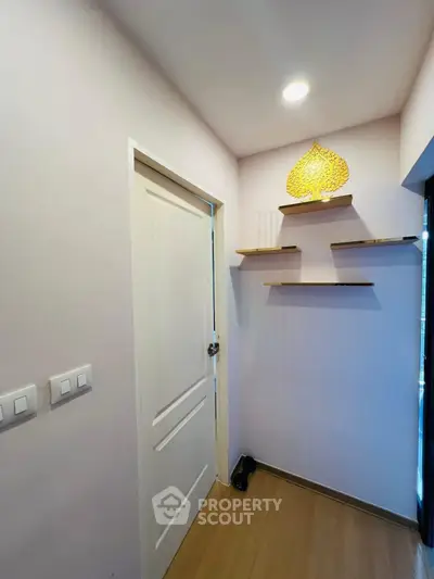 Charming entryway with modern shelving and elegant lighting, perfect for a welcoming home atmosphere.