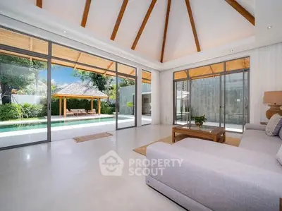 Luxurious living room with pool view and high ceilings in modern villa