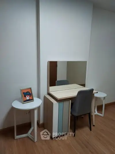 Modern study nook with sleek desk, chair, and mirror in minimalist design.