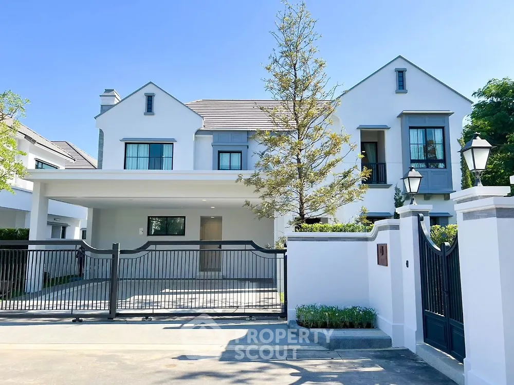 Stunning modern house with spacious driveway and elegant gated entrance, perfect for luxurious living.
