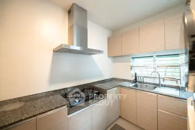Modern kitchen with sleek cabinetry and gas stove in a bright, spacious layout.