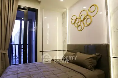 Modern bedroom with stylish decor and city view balcony access