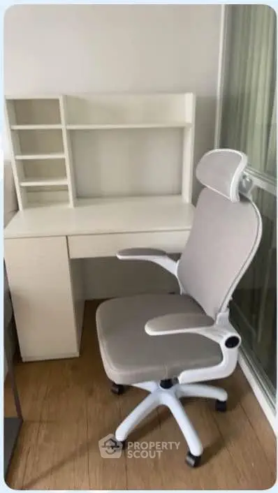 Modern study area with sleek white desk and ergonomic chair, perfect for productivity and comfort.