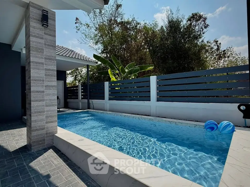 Stunning private pool area with modern design and lush greenery, perfect for relaxation and entertainment.