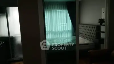 Cozy bedroom with modern decor and large window for natural light