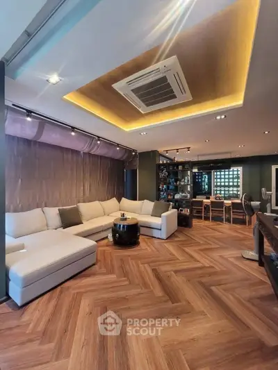 Spacious living room with modern design and elegant wood flooring
