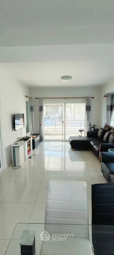 Spacious modern living room with sleek design and large windows for natural light.