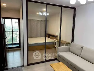 Modern apartment with glass partition, cozy living room, and balcony view.