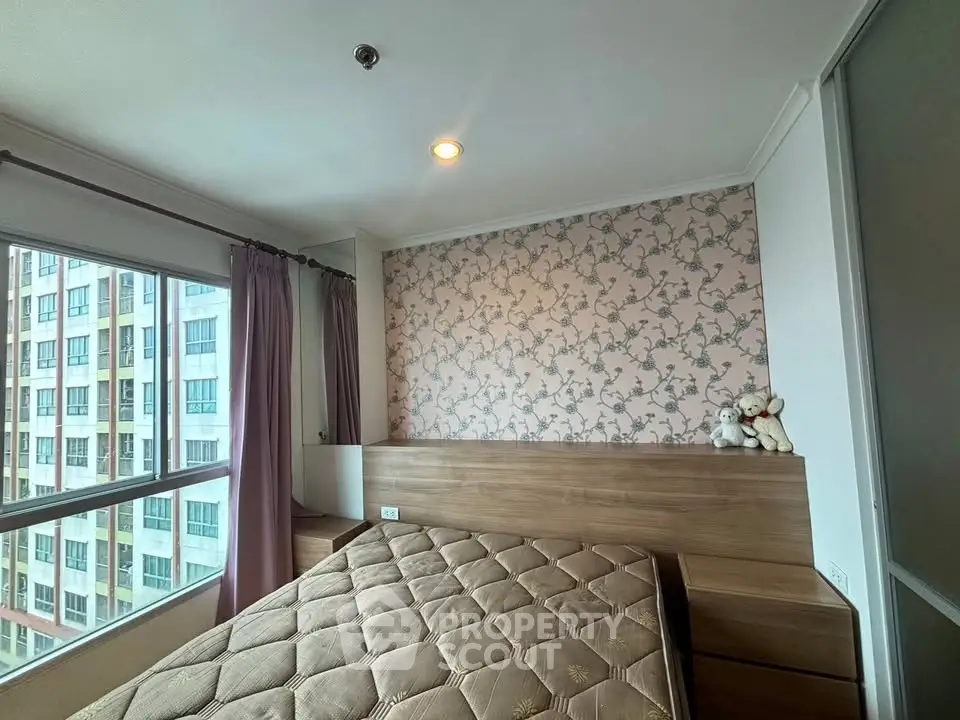Cozy bedroom with large windows and stylish wallpaper in modern apartment