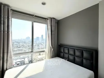 Modern bedroom with city view, featuring a stylish bed and large windows for natural light.