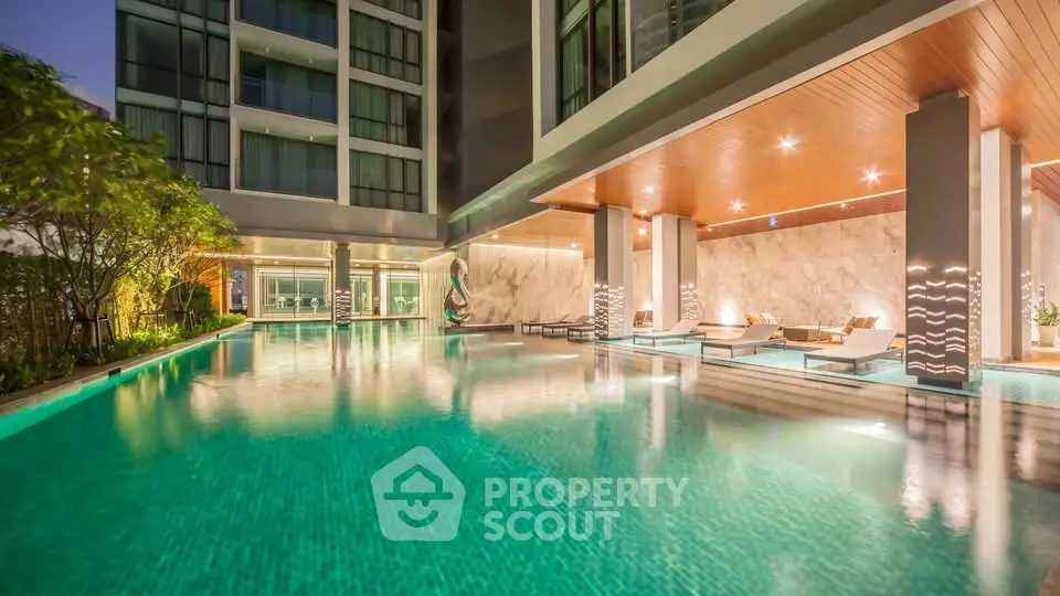 Luxurious apartment complex with stunning pool and modern design.