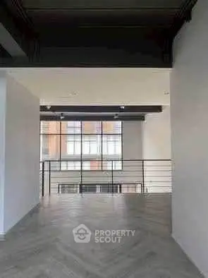 Spacious modern interior with large windows and sleek design, perfect for urban living.