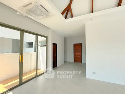 Spacious modern living room with high ceilings and sliding glass doors