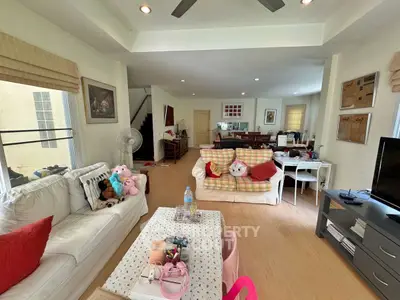 Spacious living room with cozy seating and modern decor in a bright, airy home.