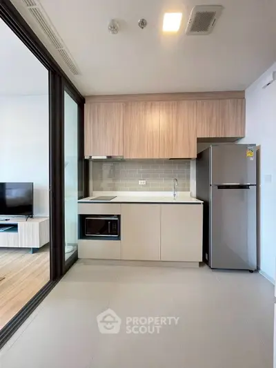 Modern kitchen with sleek appliances and open layout in stylish apartment