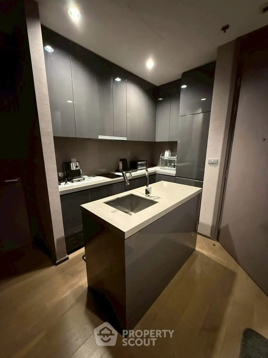 Modern kitchen with sleek cabinetry and island in contemporary apartment