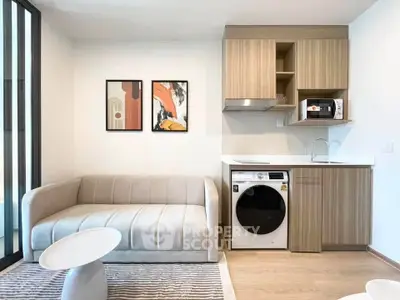 Modern living room with compact kitchen and stylish decor