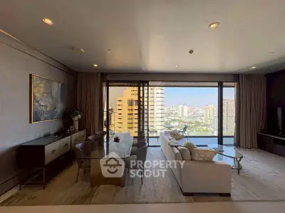 Luxurious living room with stunning city view, elegant decor, and ample natural light.