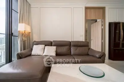 Luxurious living room with leather sofa and city view, perfect for relaxation.