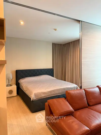 Modern bedroom with stylish leather sofa and elegant decor
