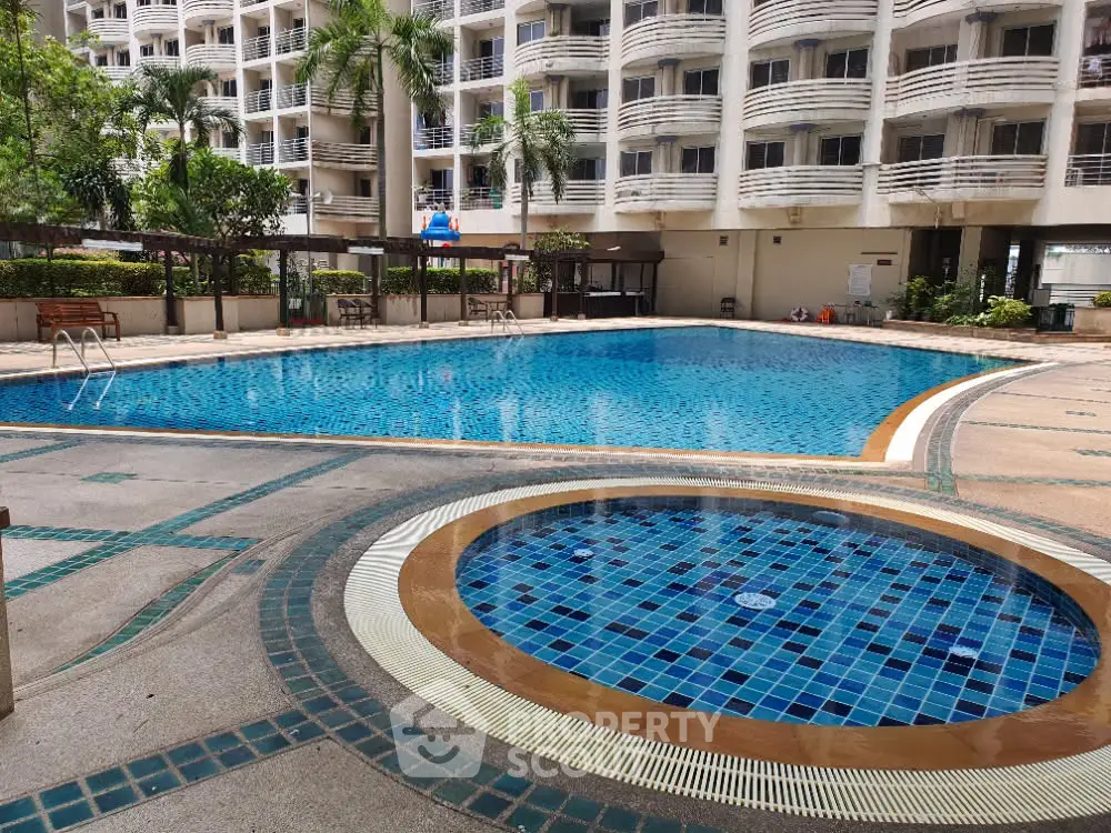 Luxurious condominium with spacious swimming pool and elegant architecture, perfect for relaxation and leisure.