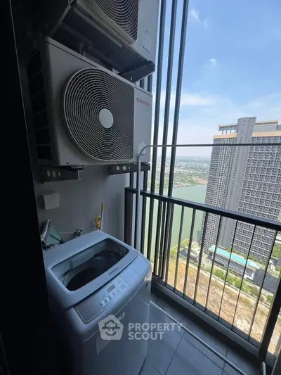 High-rise balcony with washing machine and stunning city view