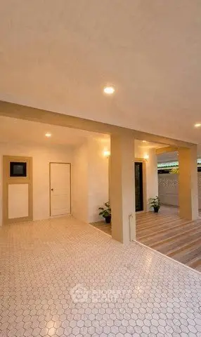 Elegant modern entrance with stylish lighting and tiled flooring