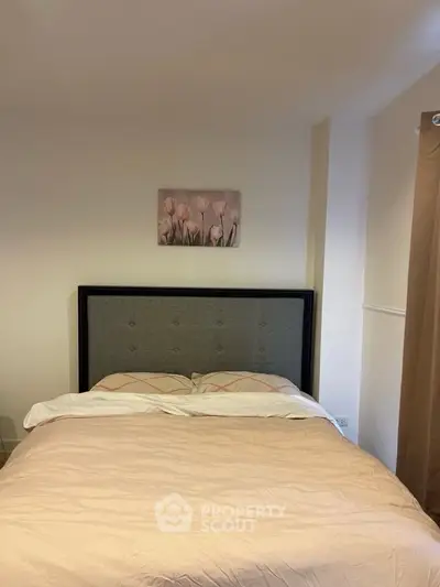Cozy bedroom with elegant decor and plush bedding, perfect for relaxation.