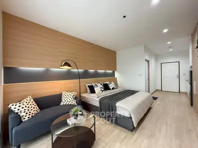 Modern bedroom with stylish decor and cozy seating area in a contemporary apartment.