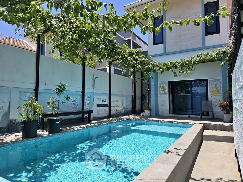 Stunning modern home with private pool and lush greenery, perfect for relaxation and entertainment.