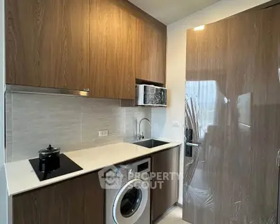 Modern kitchen with wood cabinets and built-in washing machine