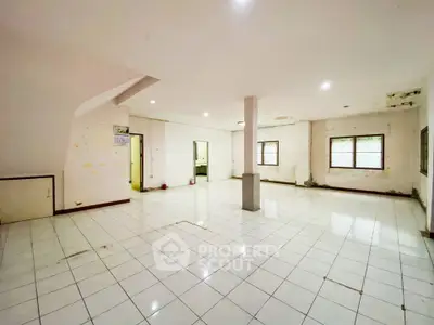 Spacious open-plan interior with tiled flooring and ample natural light, ideal for customization.