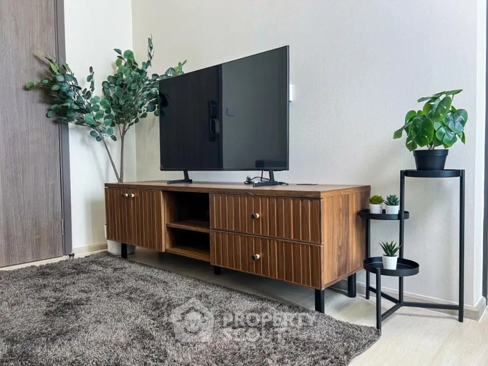 Modern living room with stylish TV stand and indoor plants