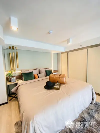 Luxurious bedroom with modern decor and plush bedding in a stylish apartment.