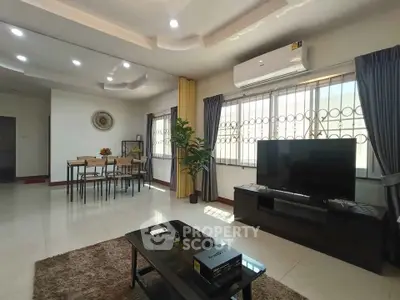 Spacious modern living room with elegant decor and large windows for natural light.