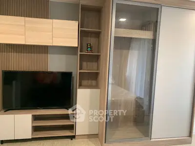 Modern living room with sleek TV unit and stylish storage solutions.