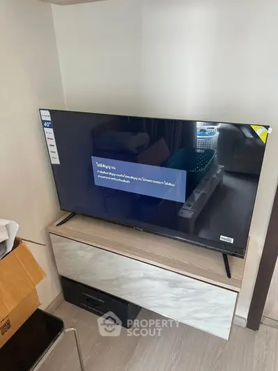 Modern living room with sleek TV setup and stylish storage unit.