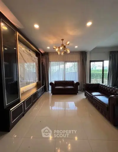 Elegant living room with luxurious leather sofas and modern chandelier