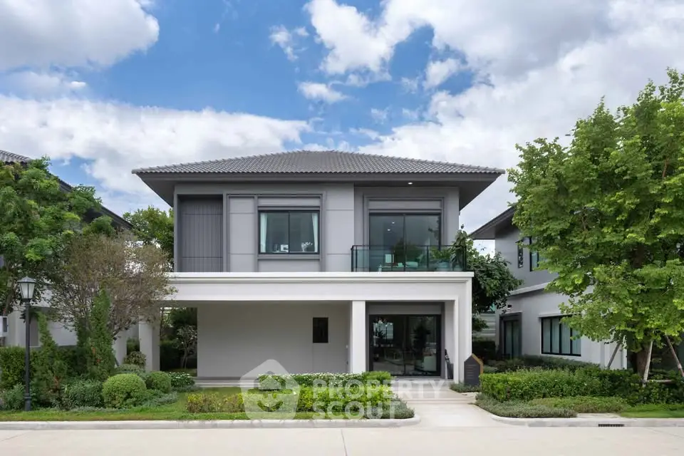 Modern two-story house with landscaped garden and driveway
