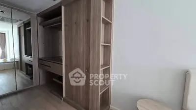 Spacious bedroom with elegant wooden wardrobe and mirrored closet doors