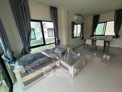 Spacious living room with modern furniture and large windows for natural light