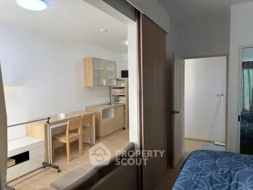 Modern studio apartment with open kitchen and cozy living area, perfect for urban living.