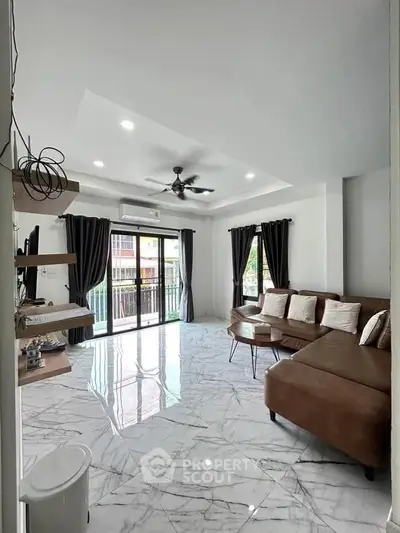 Spacious modern living room with elegant marble flooring and stylish brown sectional sofa.