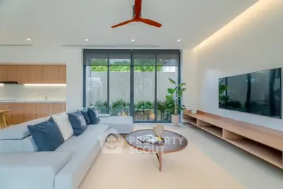 Modern living room with sleek design, large windows, and stylish furniture in a contemporary home.