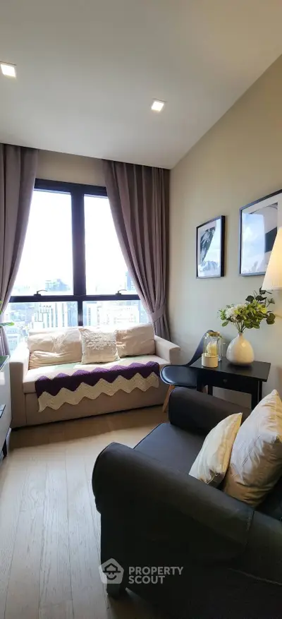 Cozy living room with city view, stylish decor, and natural light.
